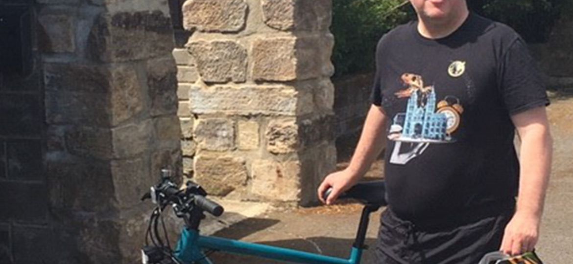 a men next to the bike on the scheme